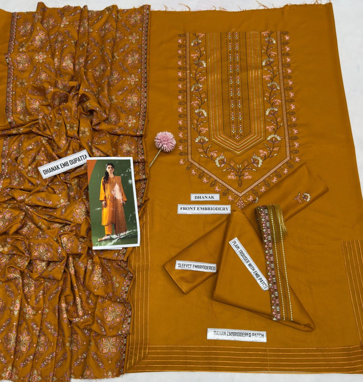 Brown fabric with embroidery and a model wearing the fabric on a white background