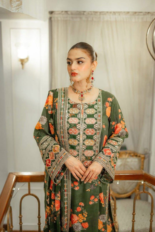 Woman wearing a green floral dress with a matching jacket indoors.